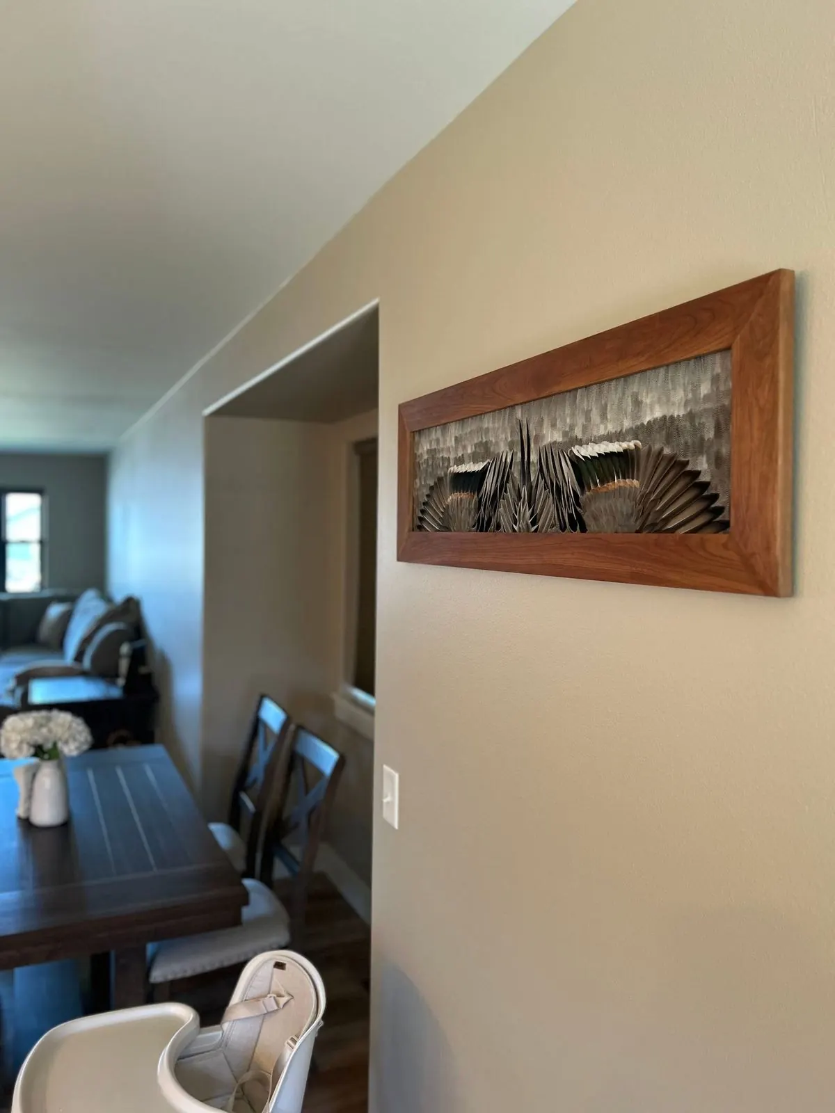 Drake pintail feather board on a dining room wall